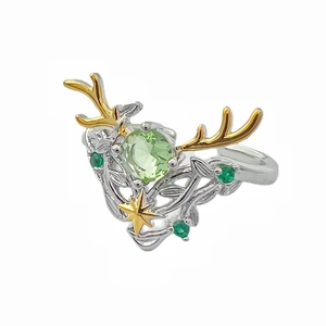 Anello aperto a corna di cervo con zircone verde e motivi di vite su fondo bianco