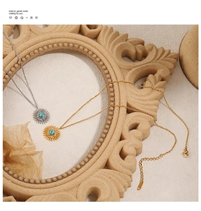Detail view of sunflower turquoise pendant necklace in gold and silver finish with adjustable chain