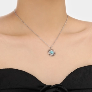 Silver sunflower necklace with turquoise stone on model with black clothing