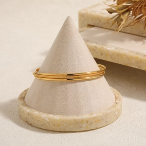Minimalist stackable gold titanium steel bangle set with polished and matte finishes