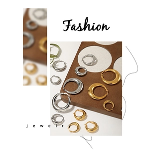 Various sizes of gold and silver chunky hoop earrings in minimalist polished finish