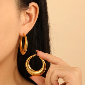 Minimalist thick gold hoop earrings in polished titanium steel for a high-end fashion look