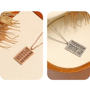 Detail of abacus pendants in gold and silver finish with fine metal craftsmanship