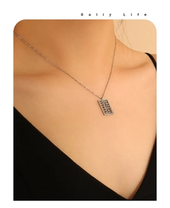 Detailed close-up of a golden abacus pendant necklace featuring movable mini beads