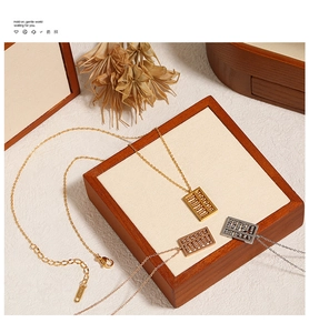 Macro detail of Chinese abacus pendant necklace in gold, rose gold and silver finishes