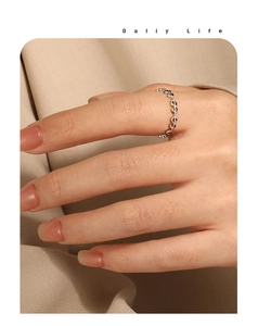 Gros plan d'une bague en acier inoxydable argenté avec motif de signe dollar continu