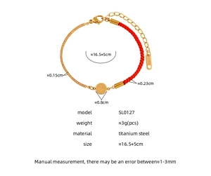 Detailed view of titanium steel Fu pendant on a red braided rope and gold chain bracelet