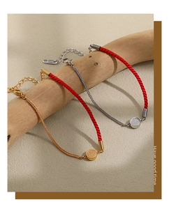 Detail of red braided Fu charm bracelets with 18KGP gold plating and lobster clasp