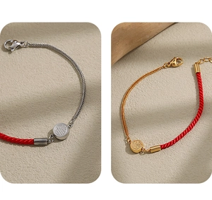 Detailed close-up of double-sided Fu character red rope and titanium steel braided bracelet