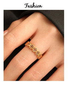 Detail of 24K PVD gold ring featuring traditional Chinese copper coin hollow pattern