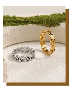 Detail of gold and silver ancient coin patterned rings on natural green moss base