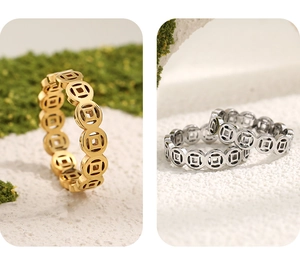 Detail of gold and silver ancient coin rings on white stone and green moss background