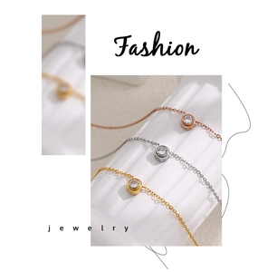 Close-up of minimalist PVD gold and silver necklaces with round cubic zirconia settings