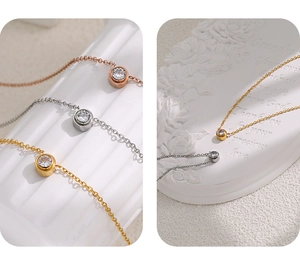Detailed close-up of bezel-set zircon pendants in gold, silver and rose gold finishes