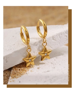 Detailed close-up of 24K gold plated star hoop earrings with clear zircon stones
