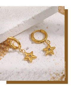 Detail view of 24K gold plated star earrings with purple zircon inlay and hoop clasp