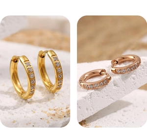 Détail macro des boucles d'oreilles créoles dorées PVD avec zircons étincelants
