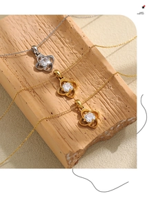 Detailed macro view of four-leaf clover necklaces with zircon in gold and silver finish