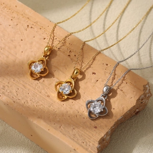 PVD gold titanium clover pendant necklace set with sparkling zircon on textured stone
