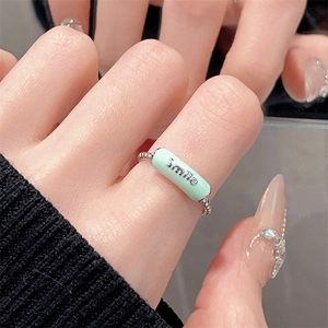 Detail of mint green Smile ring with polished silver beads on a female hand