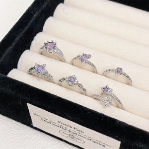 Elegante colección de anillos de circón púrpura y plata con varios diseños de flores y estrellas