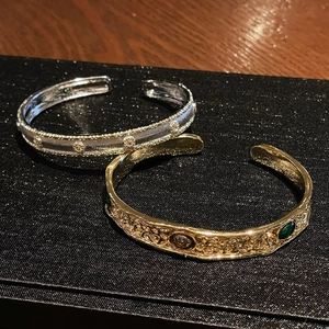 Vintage style open cuff bracelets with intricate textures and gold and silver plating