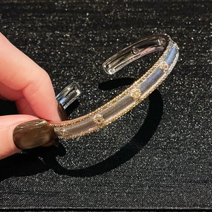 Detail of two-tone cuff bracelet showing gold beaded edges and sparkling zircons