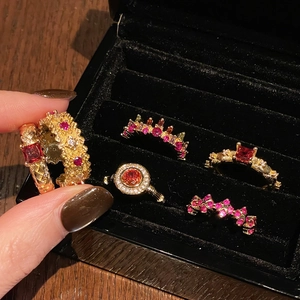 Vintage gold rings set with red and pink gemstones and sparkling zircon accents