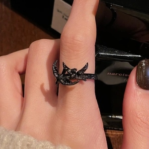Detailansicht des schwarzen Punk-Rings mit Rabenflügeln am Finger des Models