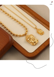 Vue détaillée des pendentifs tête de Bouddha dorés sur un plateau à bijoux élégant