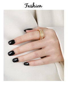 Close-up of dual-row square diamond ring in gold plating on model's hand