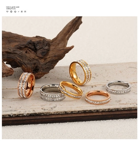 Detailed shot of gold, silver, and rose gold square-cut cubic zirconia eternity rings