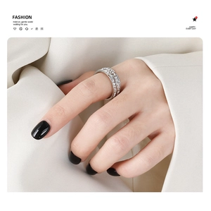 Close-up of a double-row pavé square diamond ring in a silver finish on a model's finger