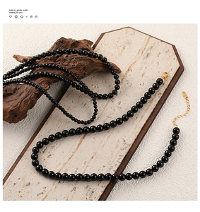Detail of black onyx beaded necklace with gold-plated lobster clasp and extender chain