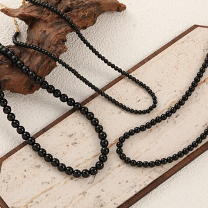 Elegant black agate bead necklace with gold lobster clasp and adjustable metal extension chain