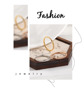 Close-up of minimalist gold, silver, and rose gold rings with inlaid zircon stones