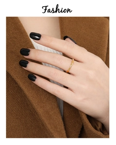 Detail of a minimalist gold-plated titanium steel ring with nine inlaid rhinestones on a hand