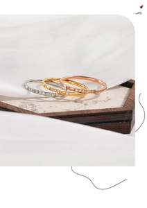 Detailed view of three-piece stackable ring set in gold, rose gold and silver finishes