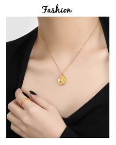 Detailed close-up of 24K gold-plated zodiac pendant necklace and minimalist ring set