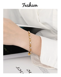 Detailed shot of gold plated bracelet featuring coffee bean links and sparkling zircons