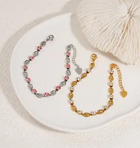 Close-up of gold and silver bean link bracelets with sparkling crystal settings