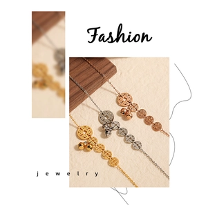 Macro shot of gold silver and rose gold anklets with copper coin charms and bells