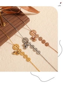 Close-up of gold-plated titanium steel anklet with five ancient coins and small bell charms