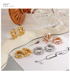 Detailed macro view of gold, rose gold and silver hoops with multi-color zircon inlay
