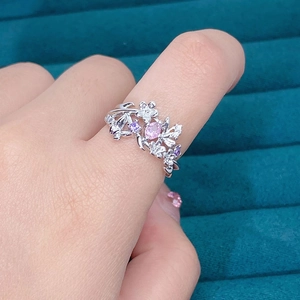 Detail of silver flower and butterfly ring with pink zircon on velvet jewelry box