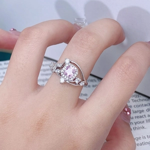 Close-up of pink zircon ring featuring a square princess cut stone on a woman's finger