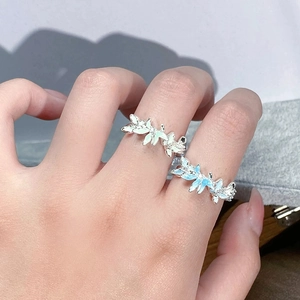 Détail de bagues fleurs en émail vert menthe et bleu ciel avec micro-incrustation