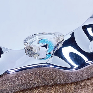 Détail macro de la bague queue de poisson avec émail bleu et petites perles