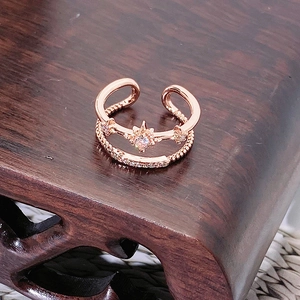 Dettaglio dell'anello a doppio strato in oro rosa con motivo a stella e zirconi