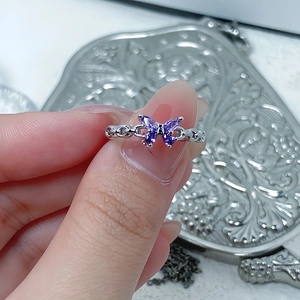 Macro shot of purple marquise zircon butterfly and hollow chain silver open ring band